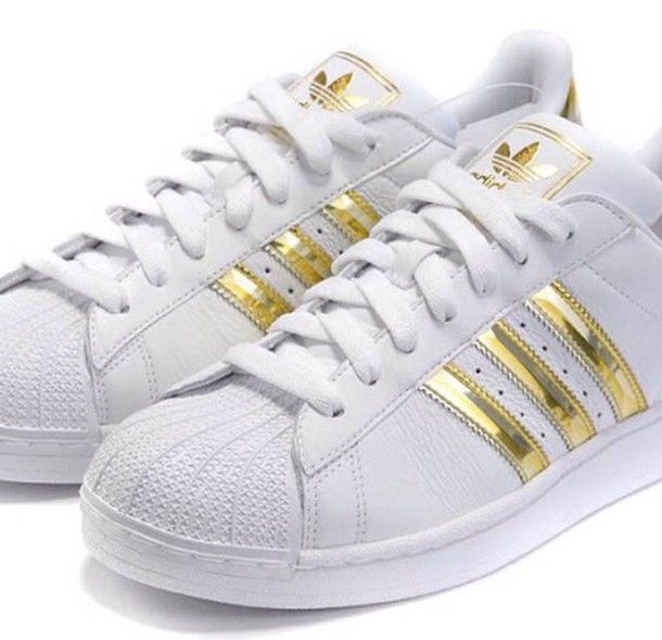 white shoes with gold stripes